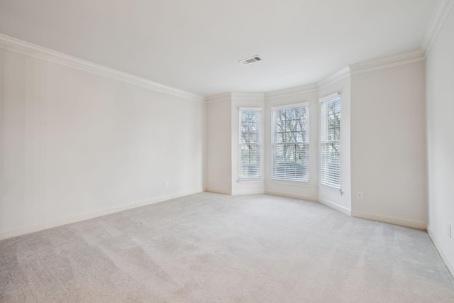 empty room featuring light carpet and crown molding