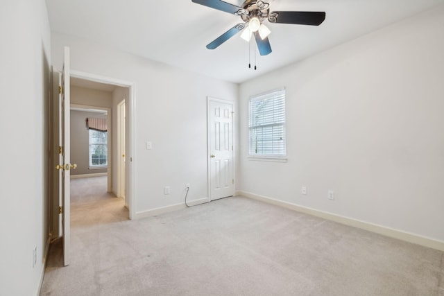 unfurnished bedroom with ceiling fan, light colored carpet, and a closet