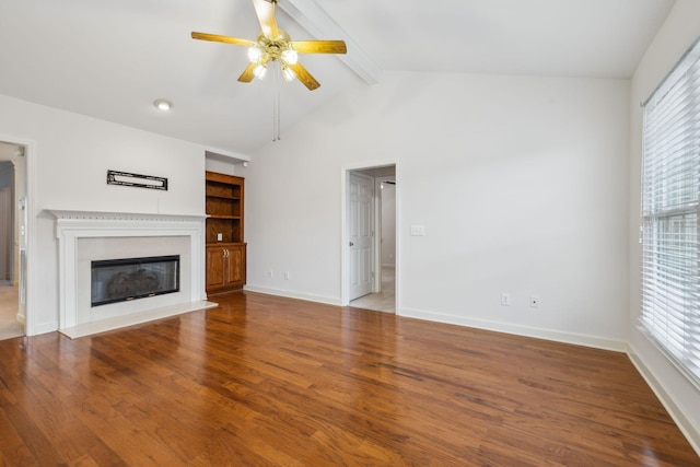 unfurnished living room with hardwood / wood-style flooring, lofted ceiling with beams, and ceiling fan