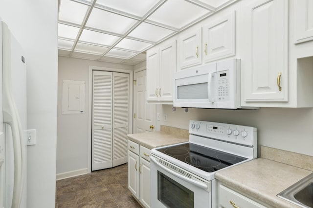 kitchen featuring white appliances and white cabinetry