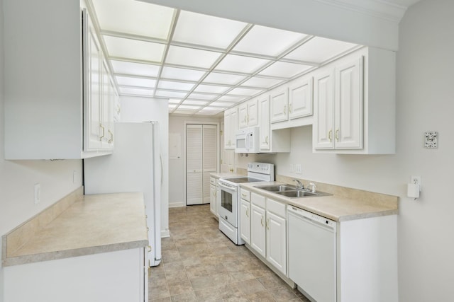 kitchen featuring white cabinetry, white appliances, and sink