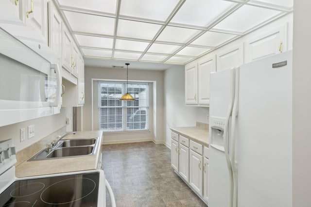 kitchen with white cabinetry, sink, pendant lighting, and white appliances