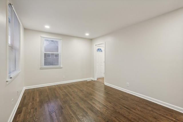 spare room with dark hardwood / wood-style flooring