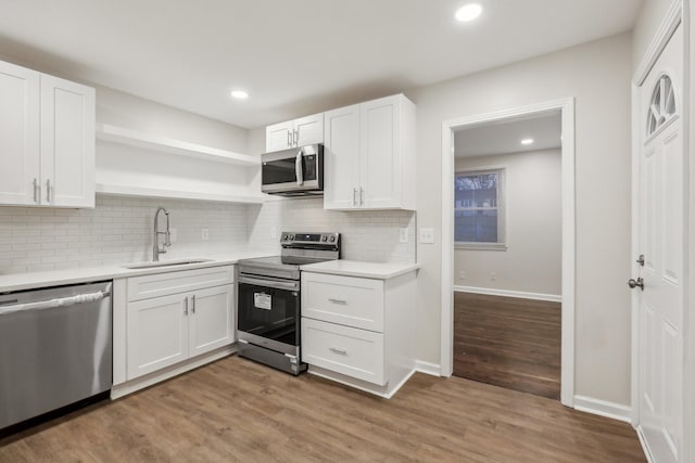 kitchen featuring white cabinetry, sink, and appliances with stainless steel finishes