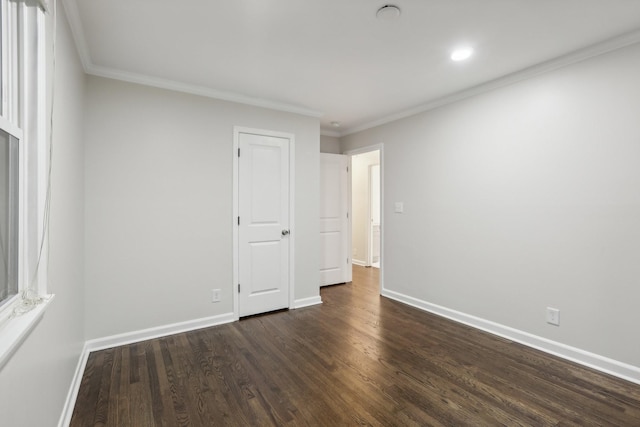 unfurnished room featuring ornamental molding and dark wood-type flooring