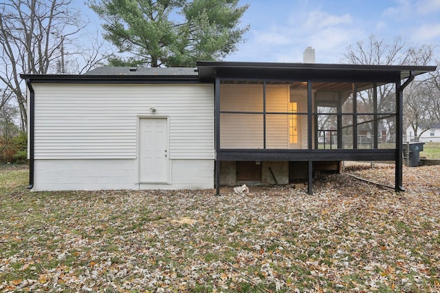 back of house featuring a sunroom