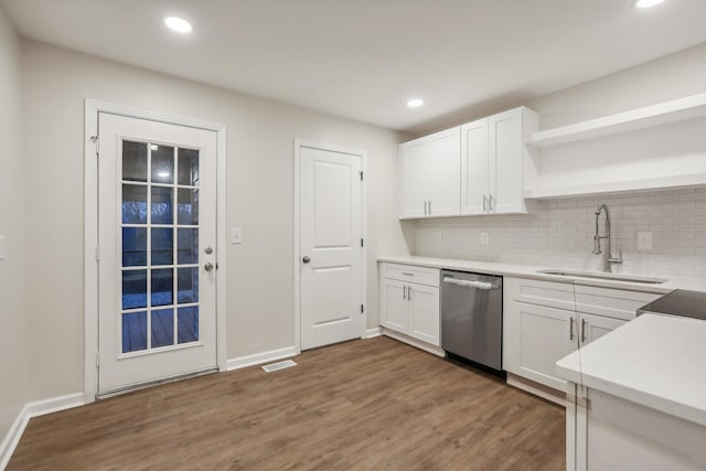 kitchen featuring dishwasher, dark hardwood / wood-style flooring, white cabinets, and sink