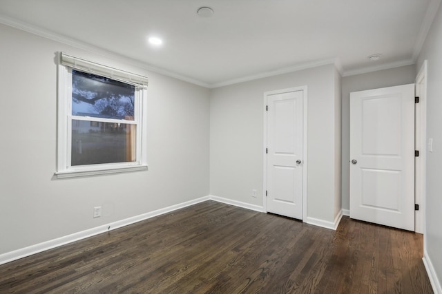 unfurnished bedroom featuring ornamental molding and dark wood-type flooring