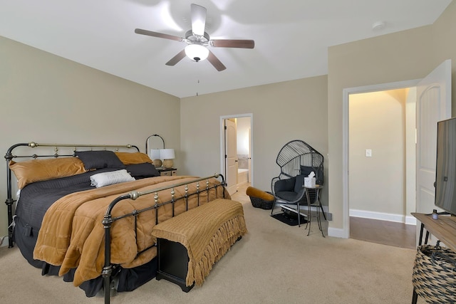 carpeted bedroom featuring ensuite bath and ceiling fan