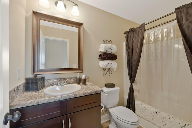 bathroom with walk in shower, vanity, and toilet