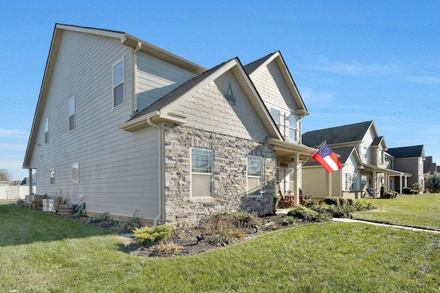 view of side of property with a lawn