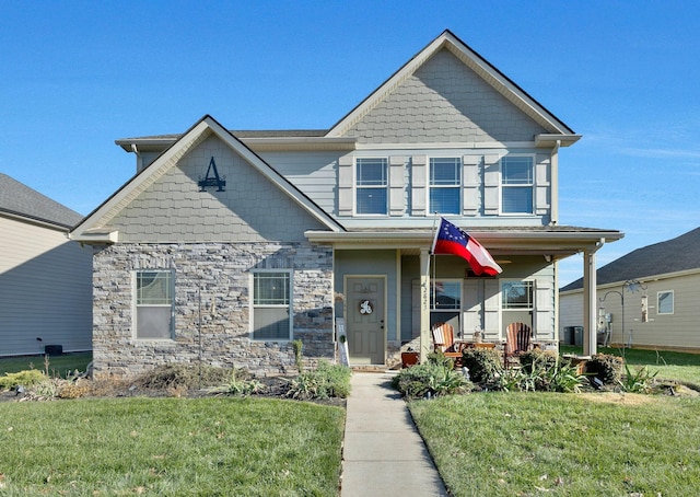 view of front of home with covered porch and a front yard