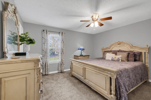 bedroom with a textured ceiling, ceiling fan, and light carpet