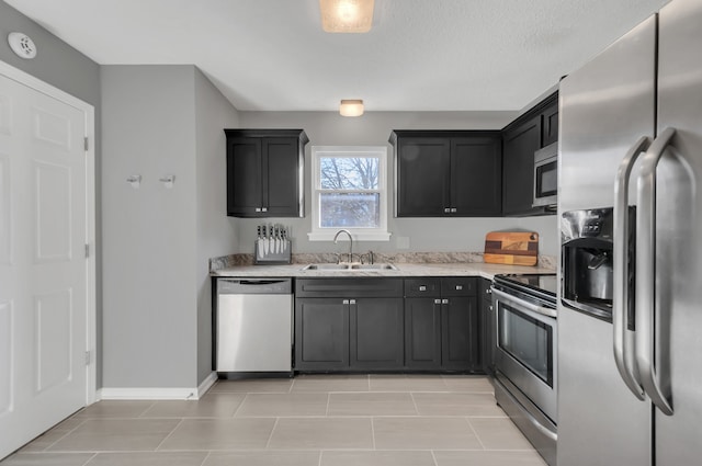 kitchen featuring light stone countertops, sink, and appliances with stainless steel finishes