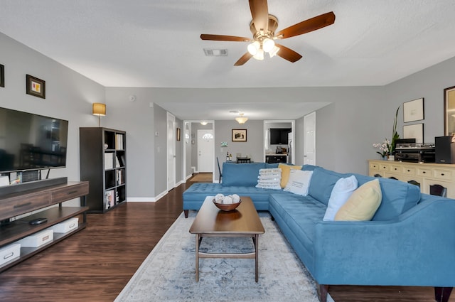 living room with ceiling fan, hardwood / wood-style floors, and a textured ceiling