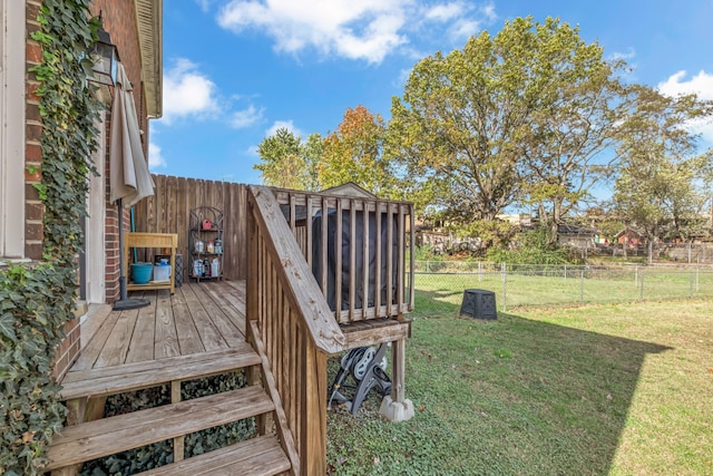 wooden terrace featuring a lawn