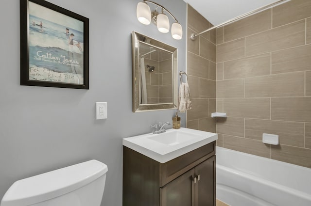 full bathroom with vanity, tiled shower / bath combo, and toilet