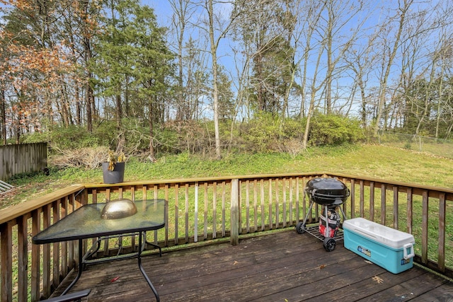 wooden terrace with a grill and a yard