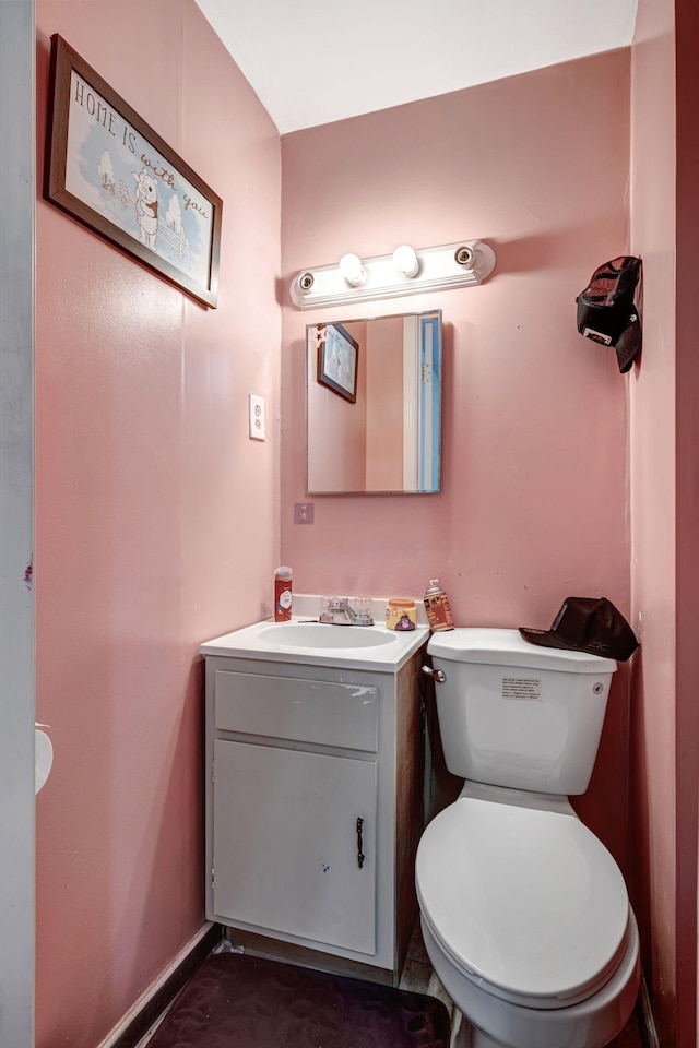 bathroom featuring vanity and toilet