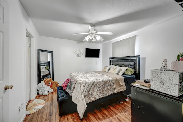 bedroom with hardwood / wood-style floors and ceiling fan