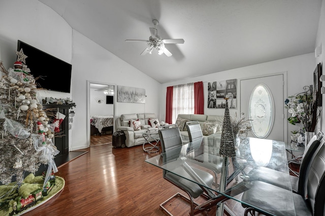 living room with dark hardwood / wood-style flooring, ceiling fan, and lofted ceiling