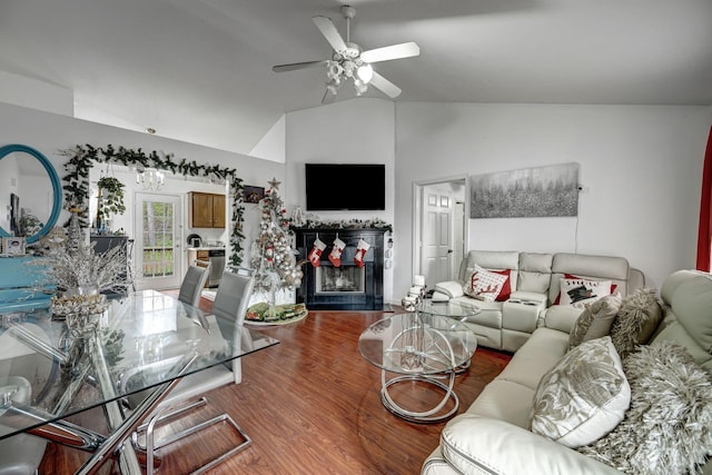 living room with hardwood / wood-style floors, ceiling fan, and vaulted ceiling