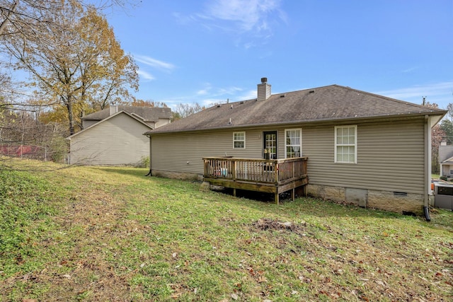 back of house with a lawn and a deck