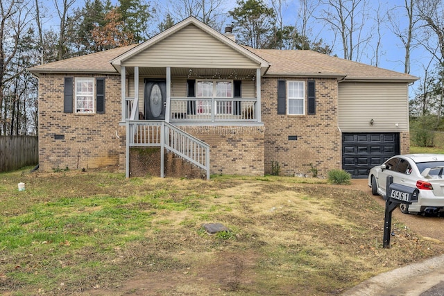 view of front of house with a porch, a garage, and a front lawn