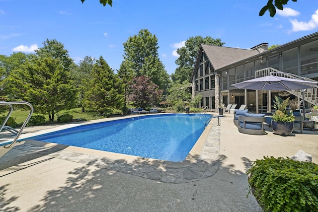 view of pool featuring a sunroom and a patio