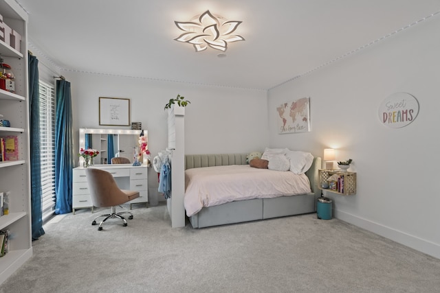 bedroom featuring light colored carpet and multiple windows