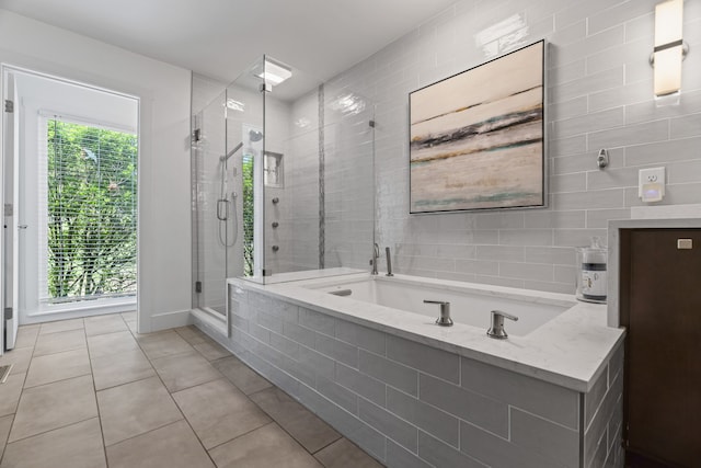 bathroom with tile patterned flooring and separate shower and tub