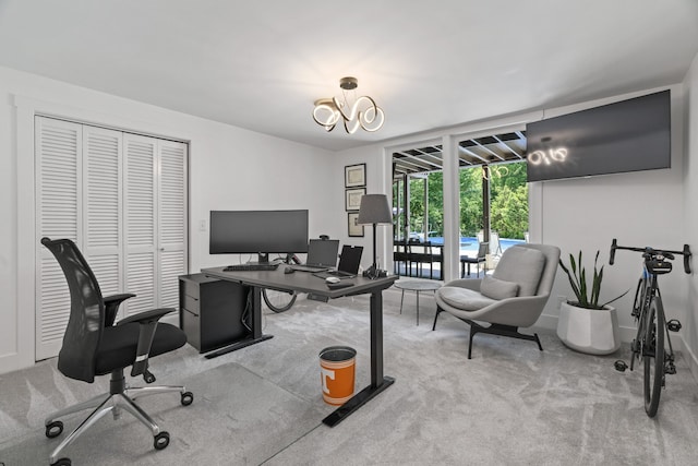 office with light colored carpet and an inviting chandelier