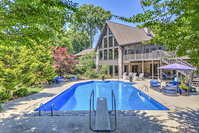 view of pool featuring a patio and a sunroom