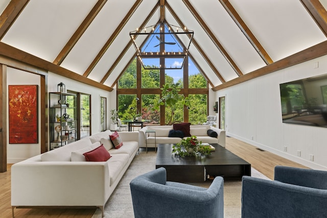 living room with beam ceiling, light wood-type flooring, high vaulted ceiling, and a notable chandelier