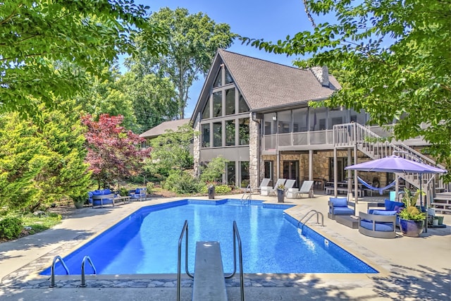 view of pool featuring a sunroom and a patio