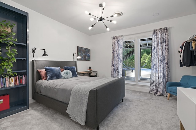 carpeted bedroom featuring an inviting chandelier