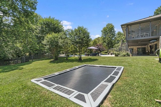 exterior space featuring a sunroom and a trampoline