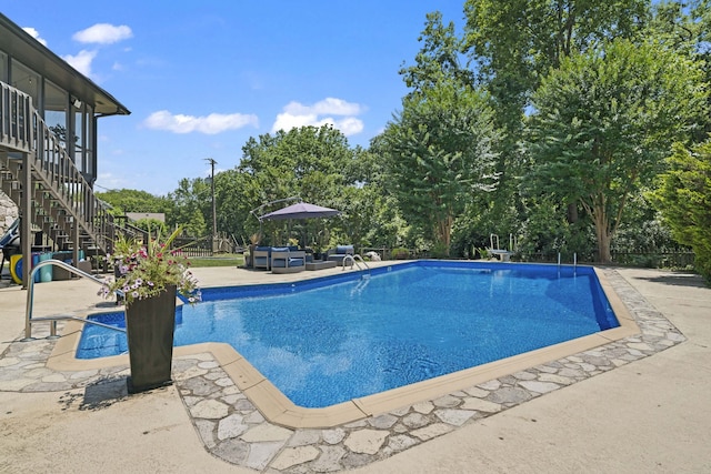 view of swimming pool featuring an outdoor living space and a patio