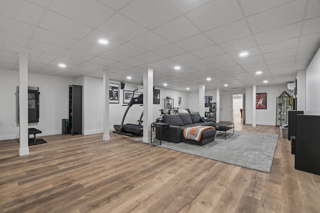 living room featuring hardwood / wood-style flooring and a drop ceiling