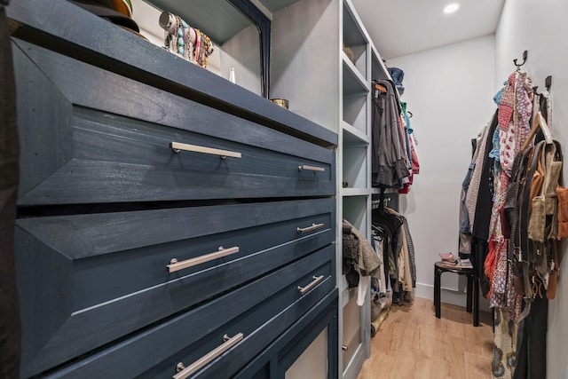 walk in closet with light wood-type flooring