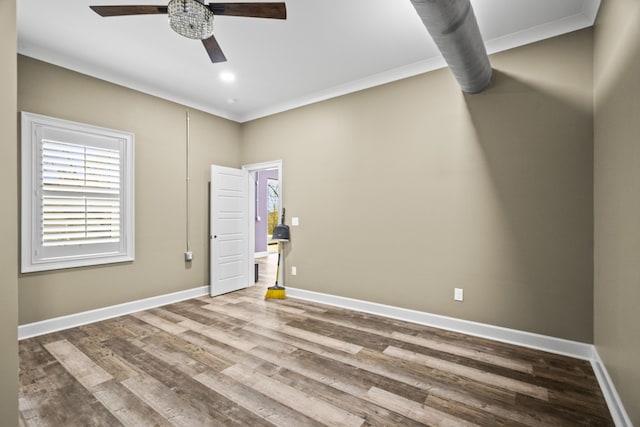 unfurnished room featuring ornamental molding, ceiling fan, and wood-type flooring