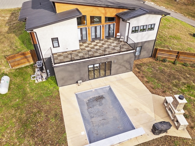 back of house with a yard and a patio