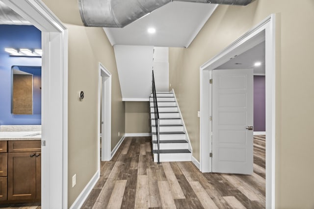 staircase with hardwood / wood-style floors