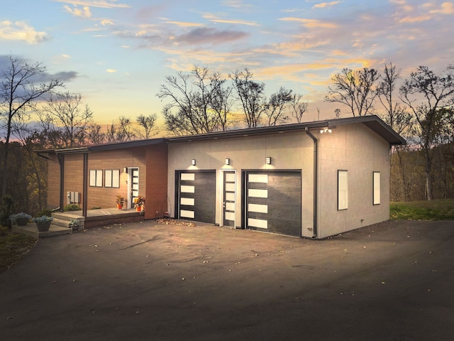 view of garage at dusk