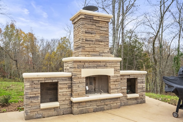 view of patio featuring grilling area and an outdoor stone fireplace