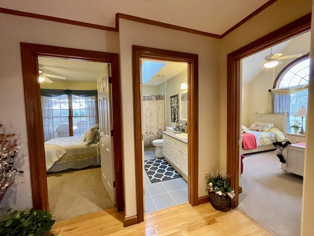314 Birdsong Dr, Cadiz, KY 42211 - hallway featuring light wood finished floors, light carpet, and crown molding