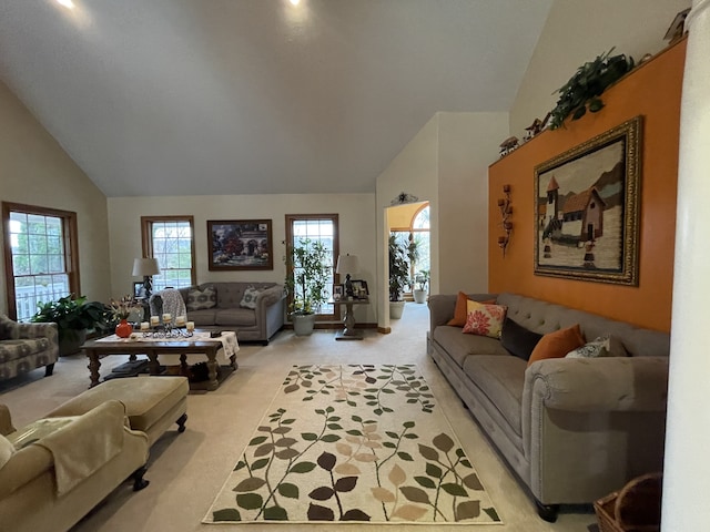 living room featuring light carpet and high vaulted ceiling