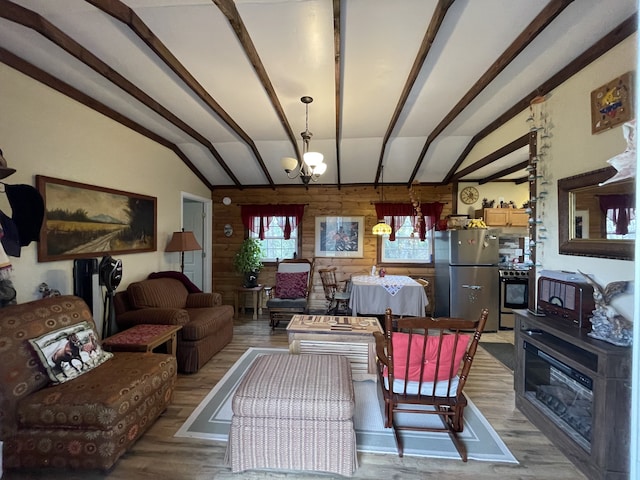 living room with hardwood / wood-style floors, lofted ceiling with beams, wooden walls, and a notable chandelier