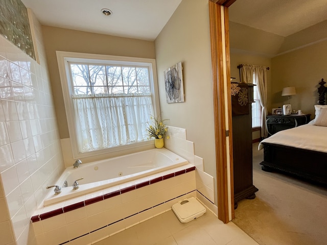 bathroom featuring tile patterned floors, lofted ceiling, and tiled bath