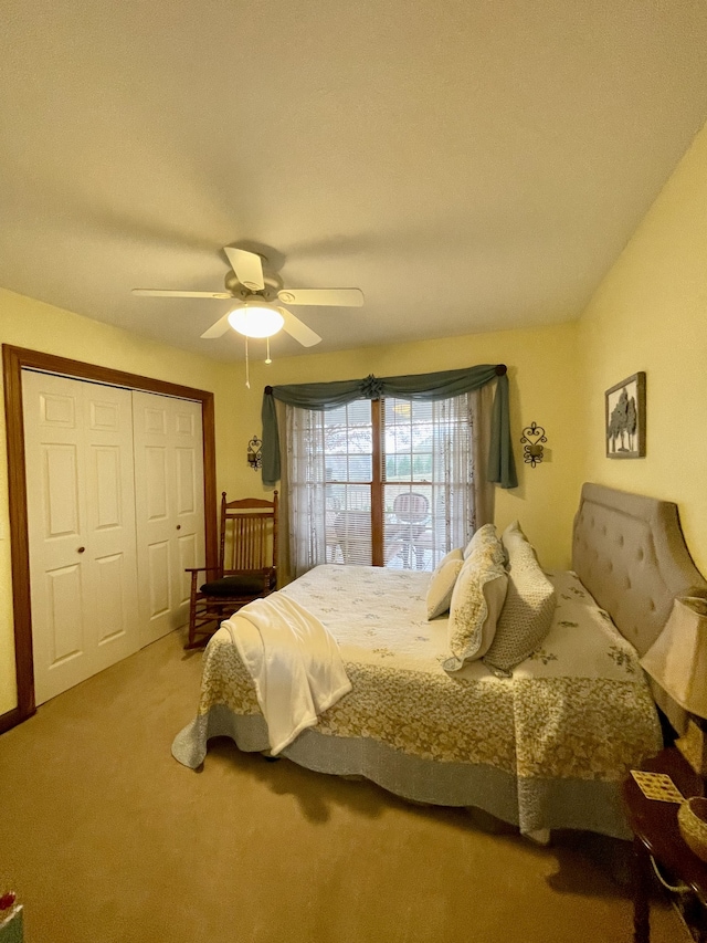 bedroom with carpet flooring, ceiling fan, and a closet